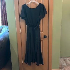 New with tags!  Elegant black dress.  Ties at the waist.  Flutter sleeve.